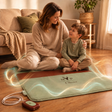 NYP Oliver PEMF mat with a woman and child meditating, showing energy waves.